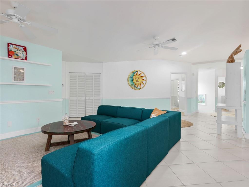 White tile flooring throughout, recessed lighting, and dual ceiling fans