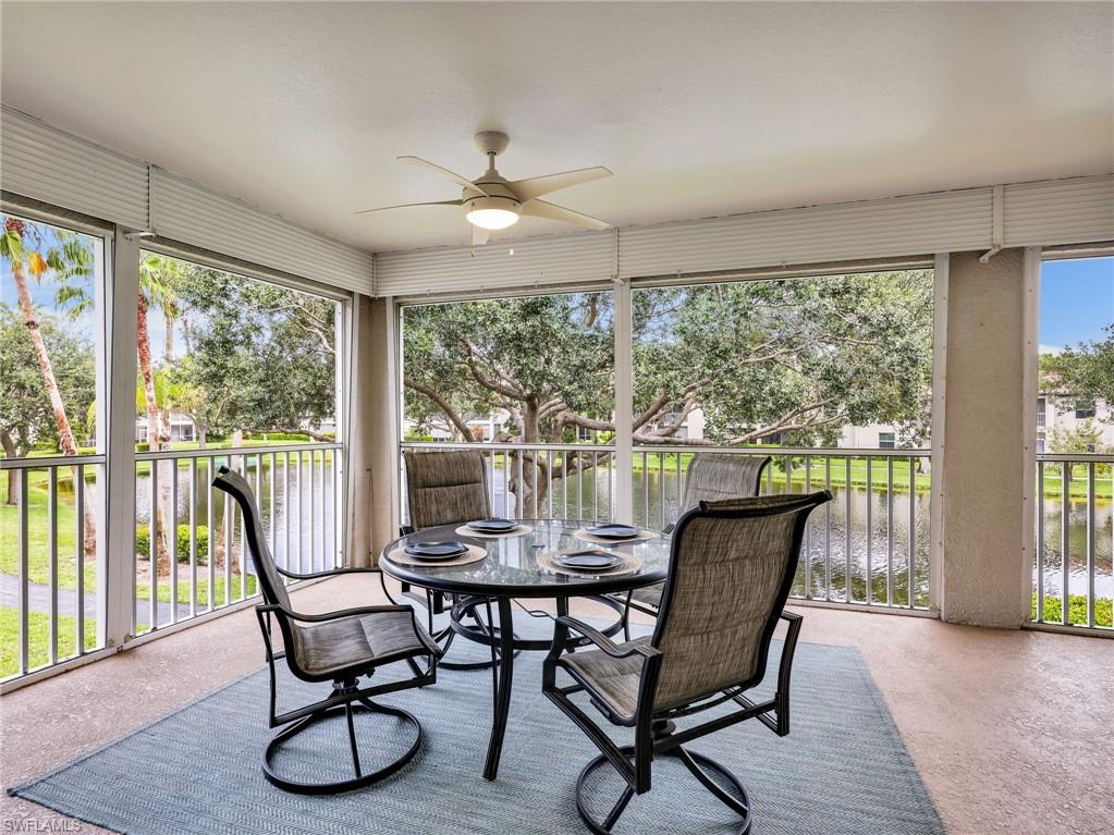 Screened outdoor living area with a ceiling fan, offering direct water frontage