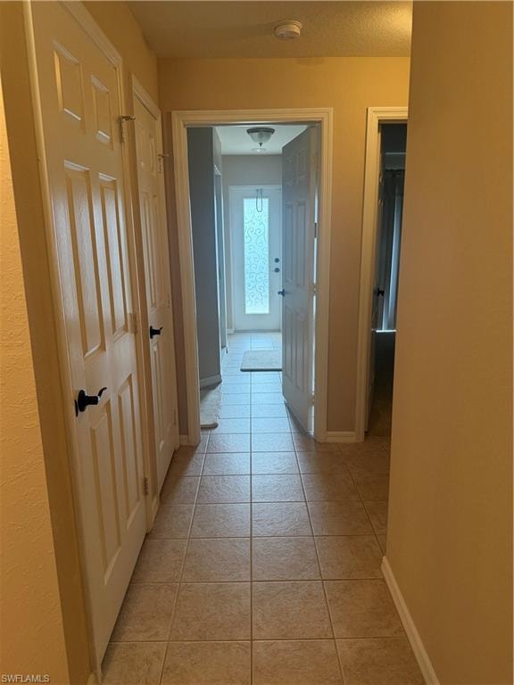 Hallway has entrances to two bedrooms and bath that leads to exterior of home.