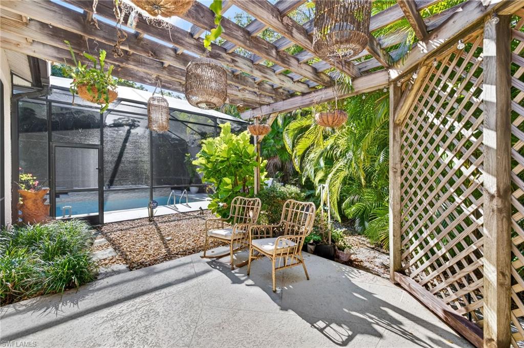 View of patio featuring glass enclosure and a sunroom