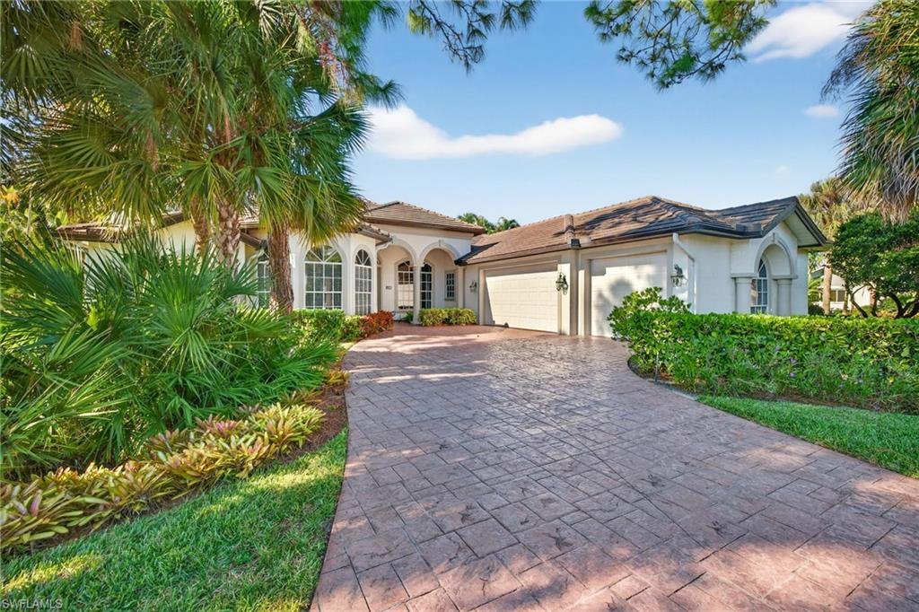 Mediterranean / spanish home featuring stucco siding, a garage, and decorative driveway