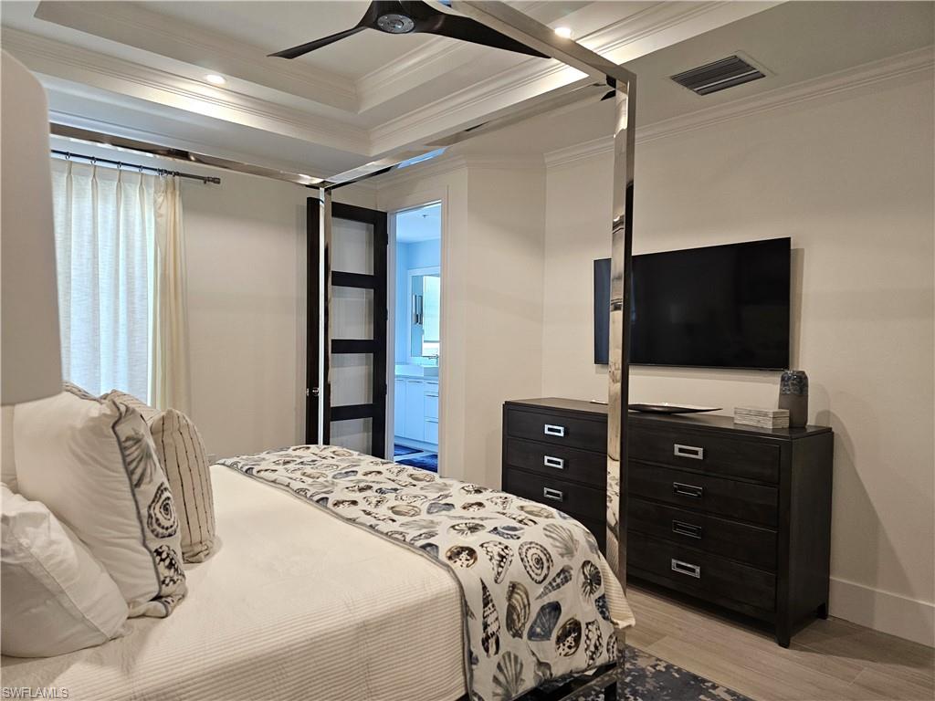 Bedroom with ornamental molding, light wood-type flooring, a ceiling fan, and recessed lighting