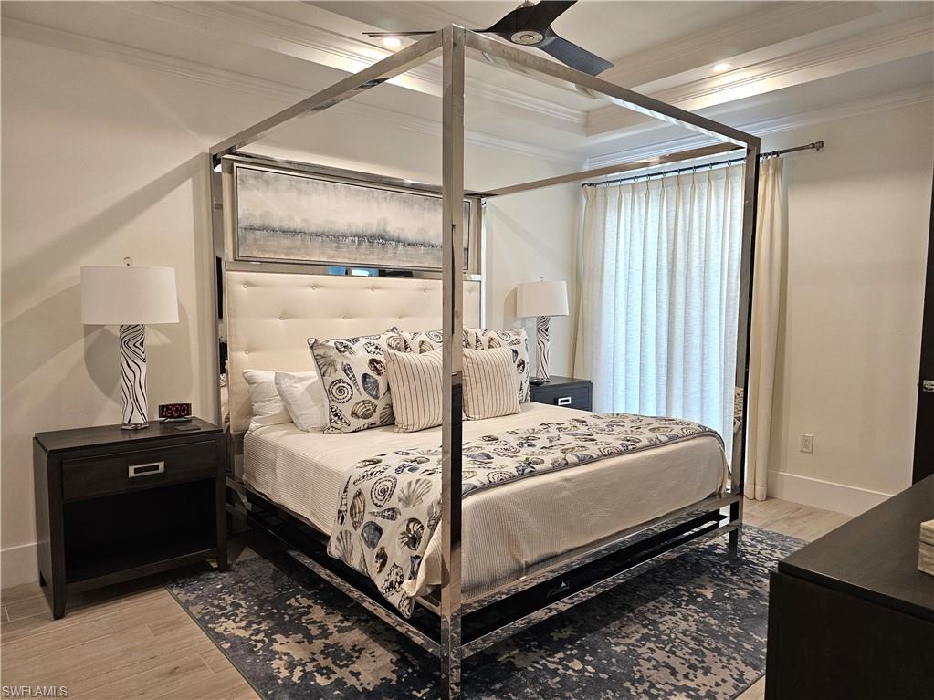 Bedroom with crown molding and light wood-style flooring