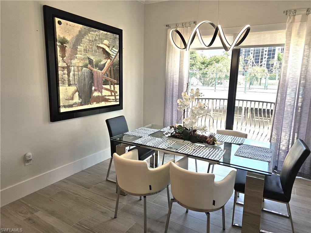 Dining space featuring wood finished floors and baseboards