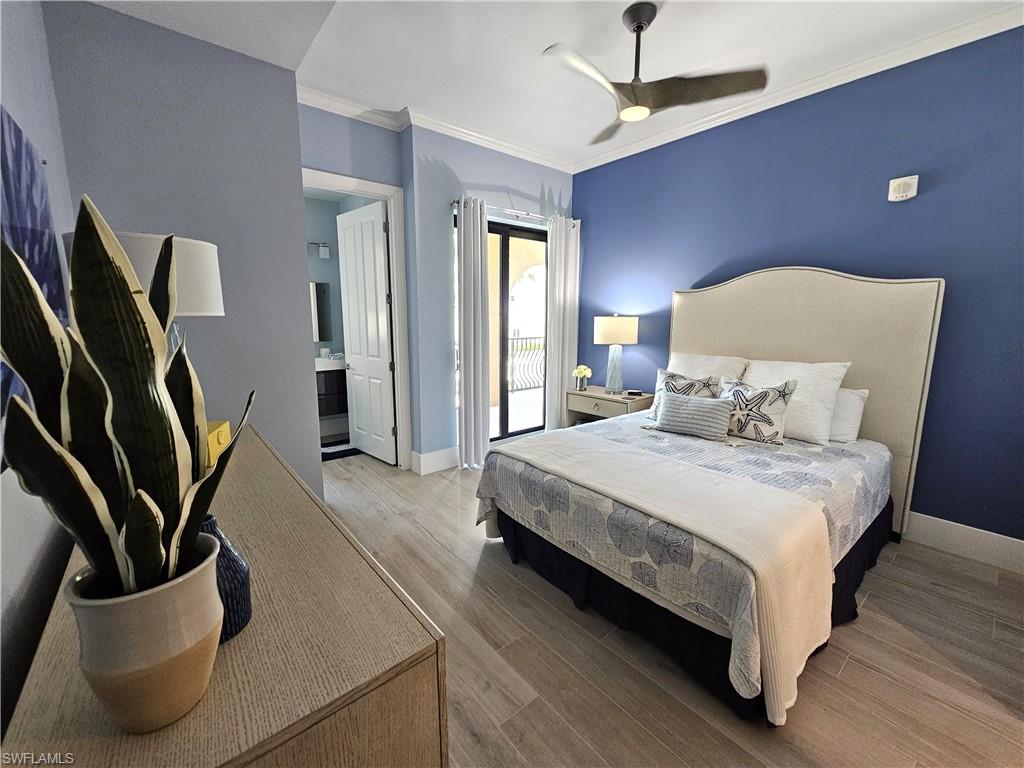 Bedroom with crown molding, wood finished floors, access to exterior, ceiling fan, and ensuite bath