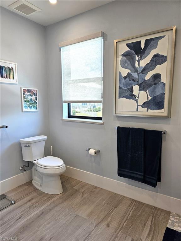 Bathroom featuring baseboards and light wood-style floors