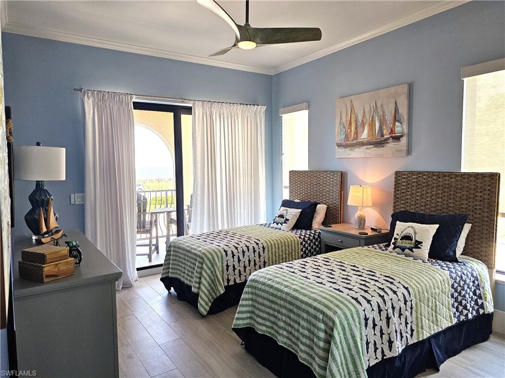 Bedroom with ornamental molding, access to outside, wood finished floors, and a ceiling fan