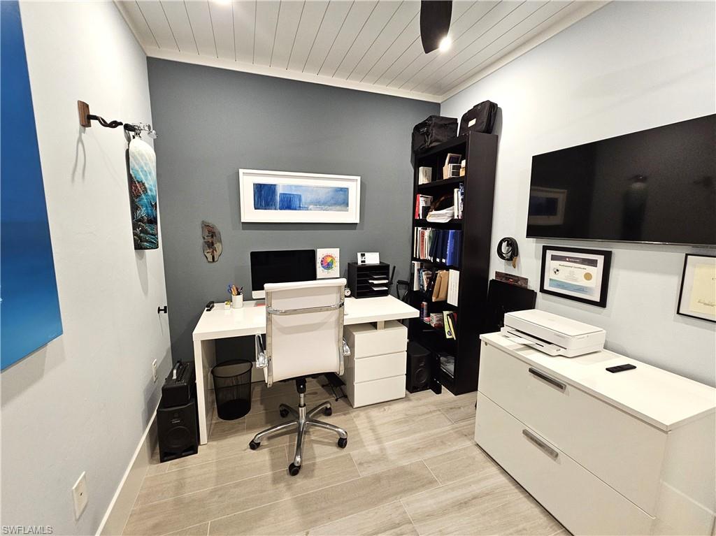Office area with wood ceiling and light wood-style floors