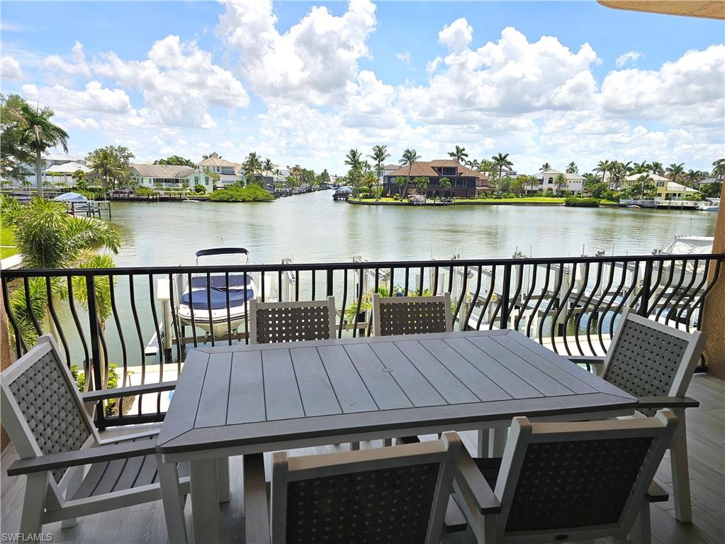 Balcony featuring a residential view and a water view