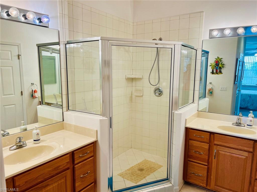 Dual wood-finish vanities with integrated sinks and chrome fixtures