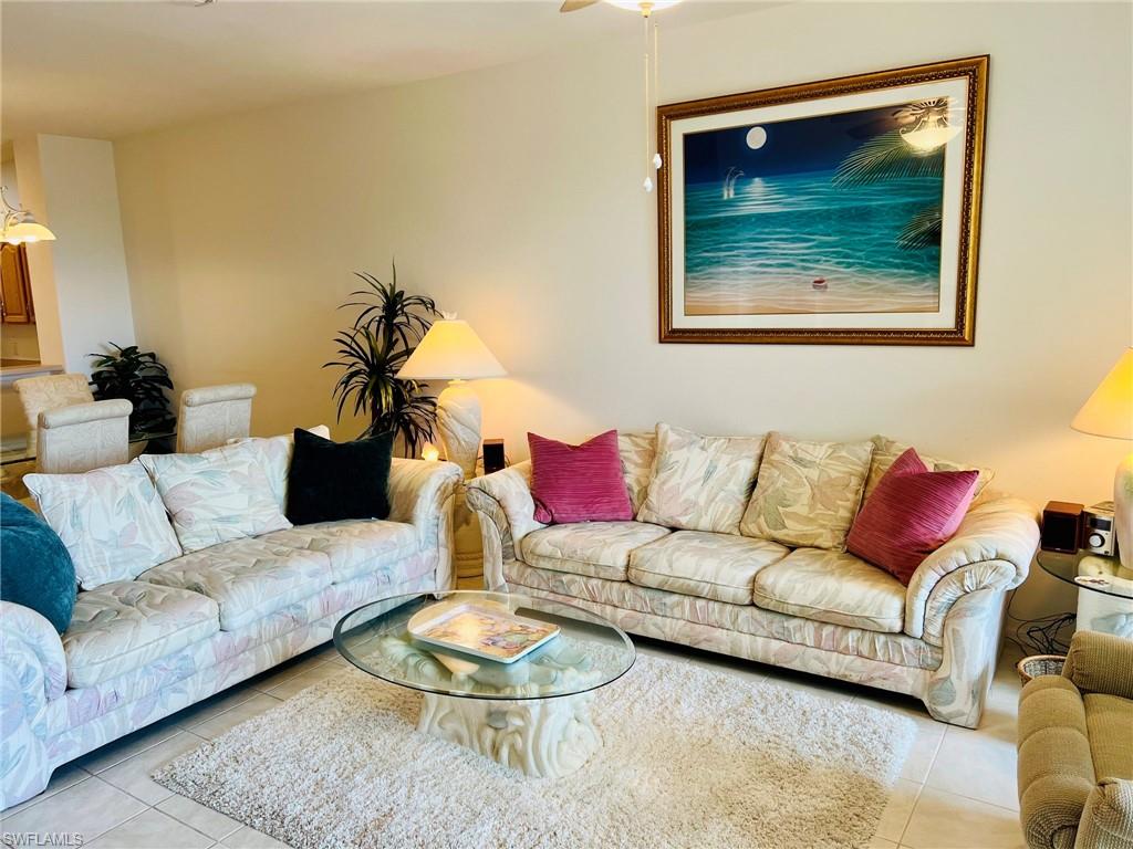 Neutral wall paint, tiled flooring, ceiling fan, decorative wall art, and ambient lighting