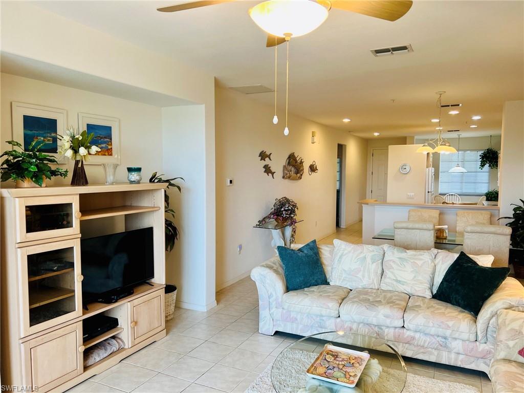 Recessed lighting, ceiling fan, tile flooring, built-in media console, and breakfast bar