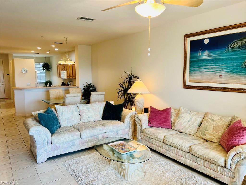 Tiled flooring throughout, recessed lighting, and a ceiling fan with integrated lighting