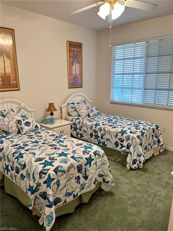 Recessed window with horizontal blinds, ceiling fan with integrated lighting, and wall-to-wall carpeting