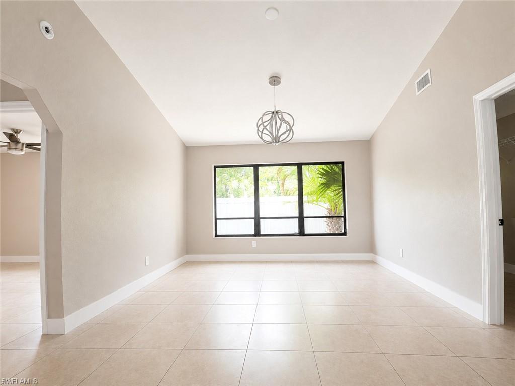 Recessed lighting, contemporary chandelier, tile flooring, large window, and light neutral wall colors