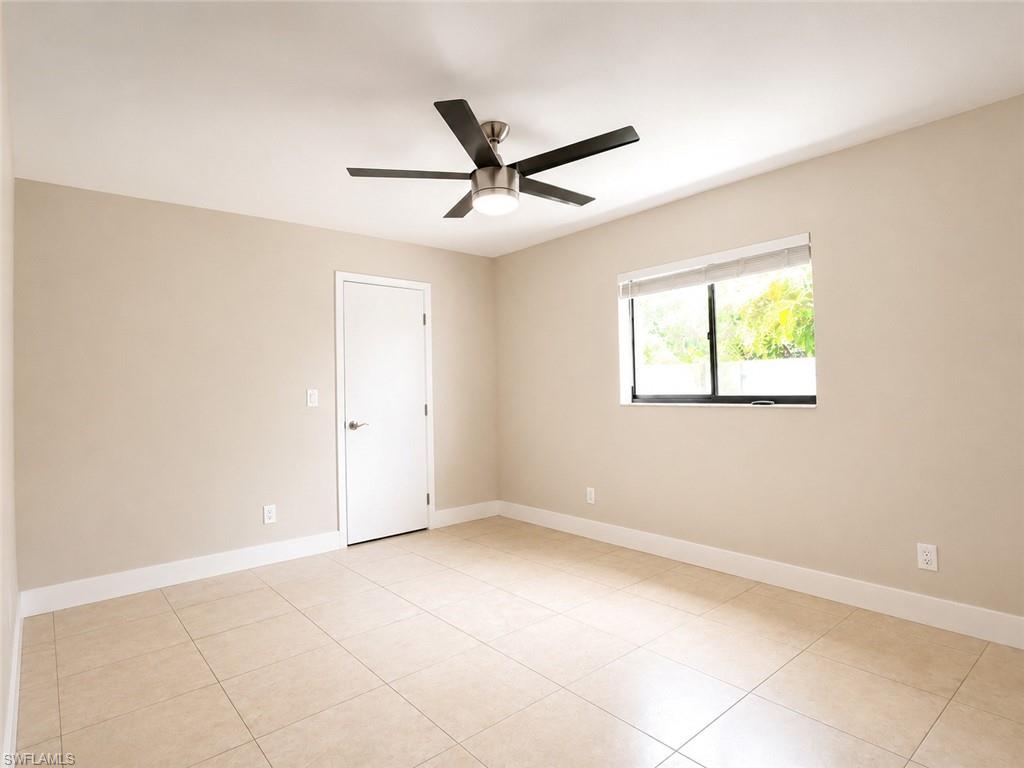 Neutral tone walls, tile flooring, modern ceiling fan with integrated lighting, and a single window