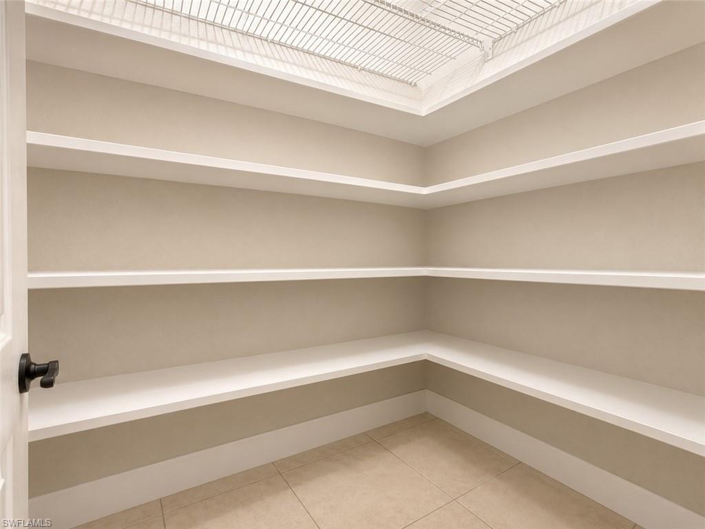 Recessed ceiling with integrated wire shelving, multiple built-in shelving units, and tile flooring