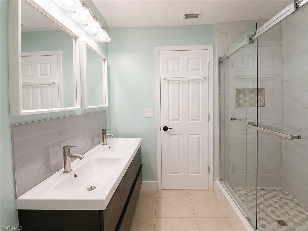 Double vanity with two integrated sinks and brushed nickel faucets