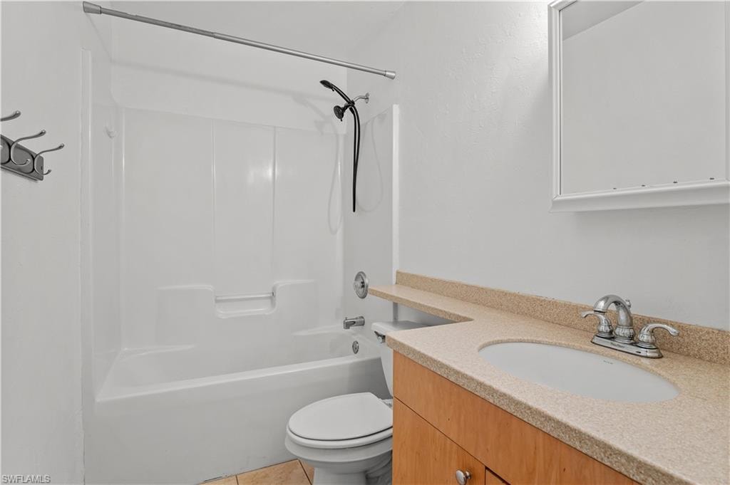 Full bathroom featuring tile floors, shower / washtub combination, large vanity, and toilet