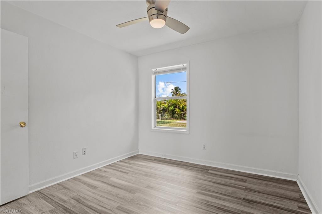 Bedroom with ceiling fan and light hardwood / wood-style flooring