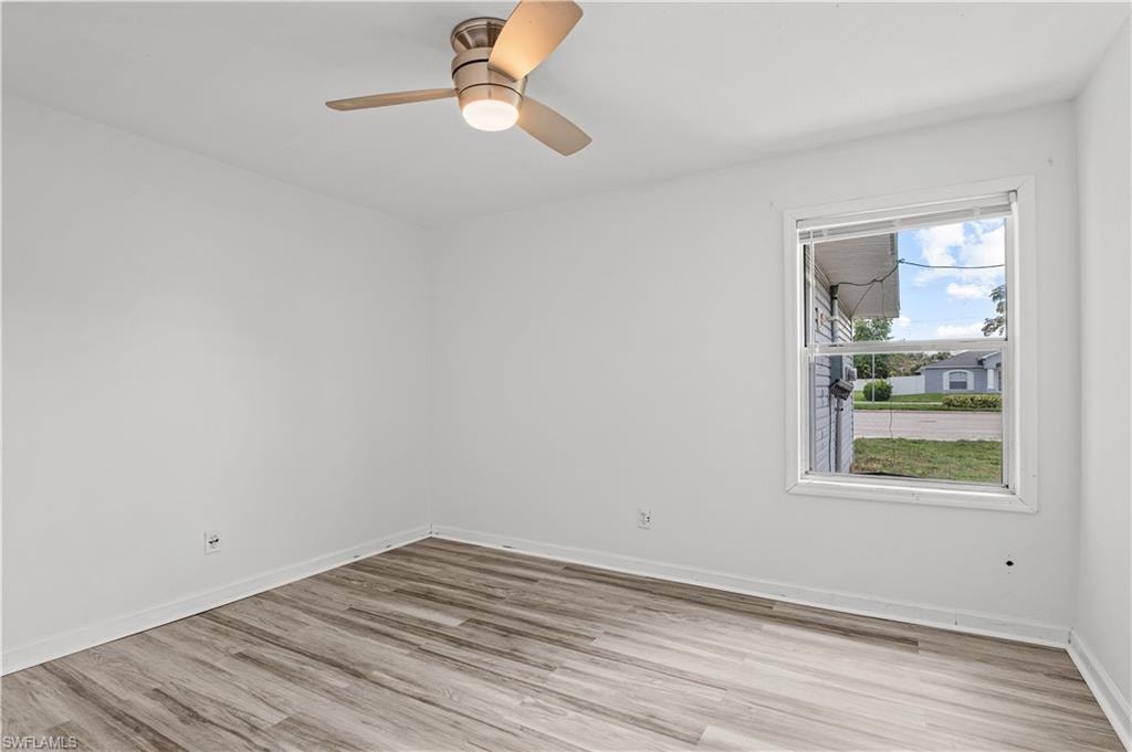 Bedroom with ceiling fan and light hardwood / wood-style flooring