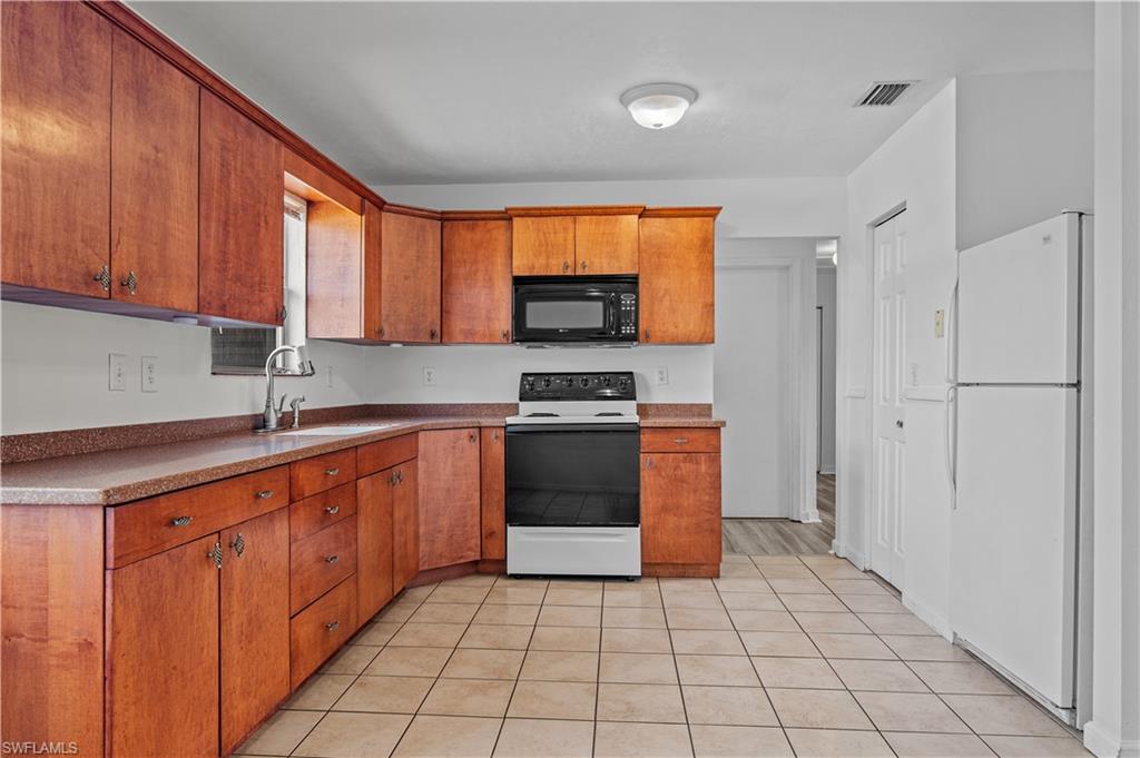 Kitchen with sink, tile floors and appliances