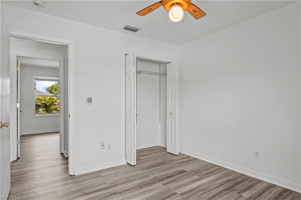 Unfurnished bedroom featuring a closet, ceiling fan, and light wood-type flooring