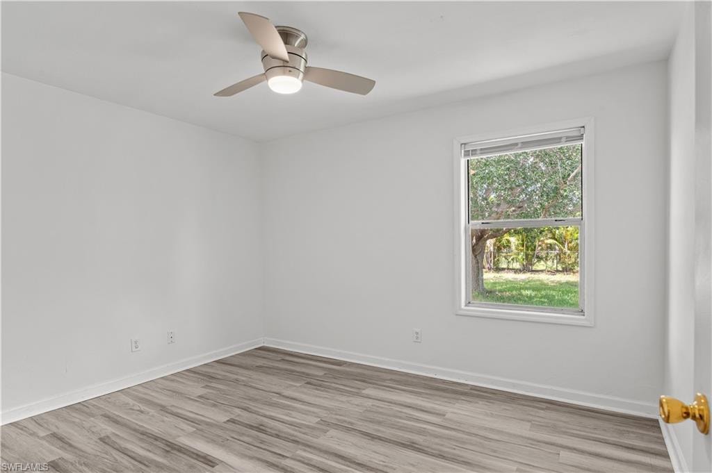 Empty room featuring ceiling fan and light hardwood / wood-style flooring