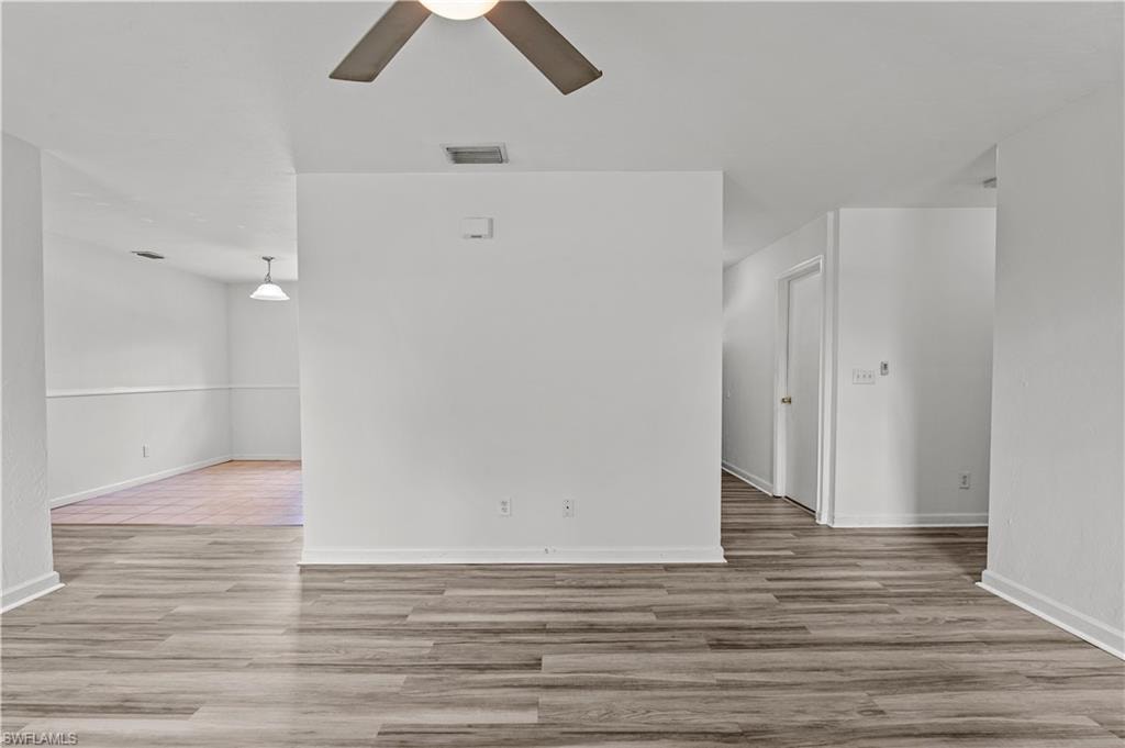 Empty room with tile flooring and ceiling fan