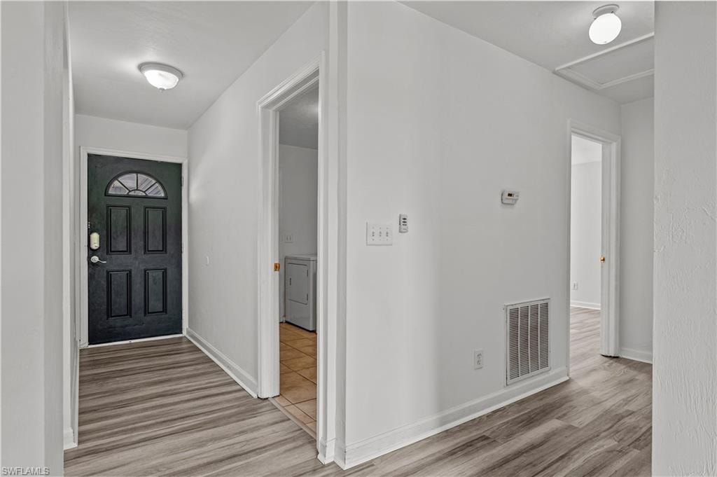 Tiled foyer entrance and laundry room featuring washer / clothes dryer