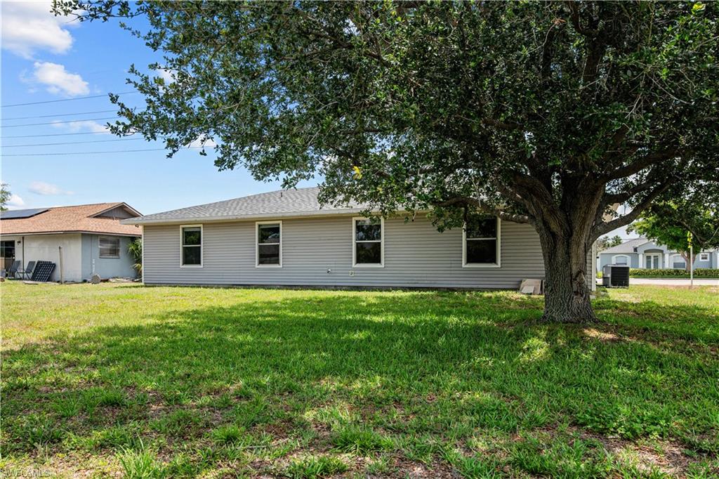 Rear view of house with a lawn