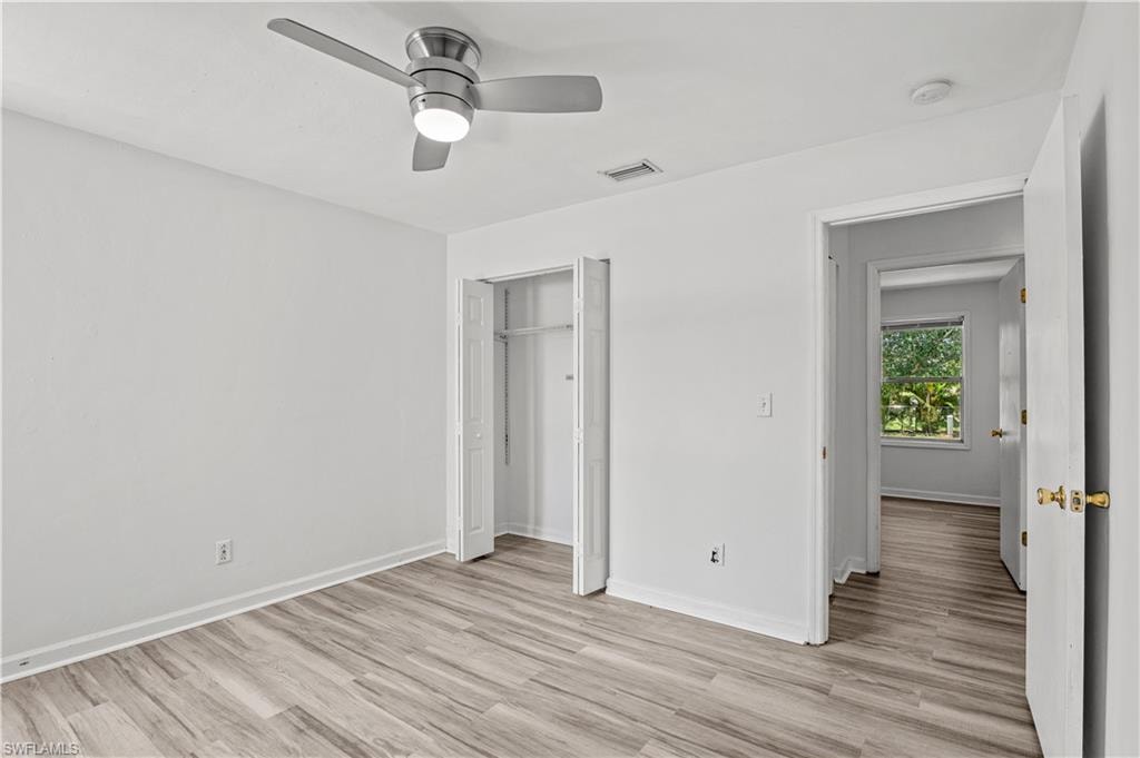 Unfurnished bedroom featuring a closet, ceiling fan, and light hardwood / wood-style floors