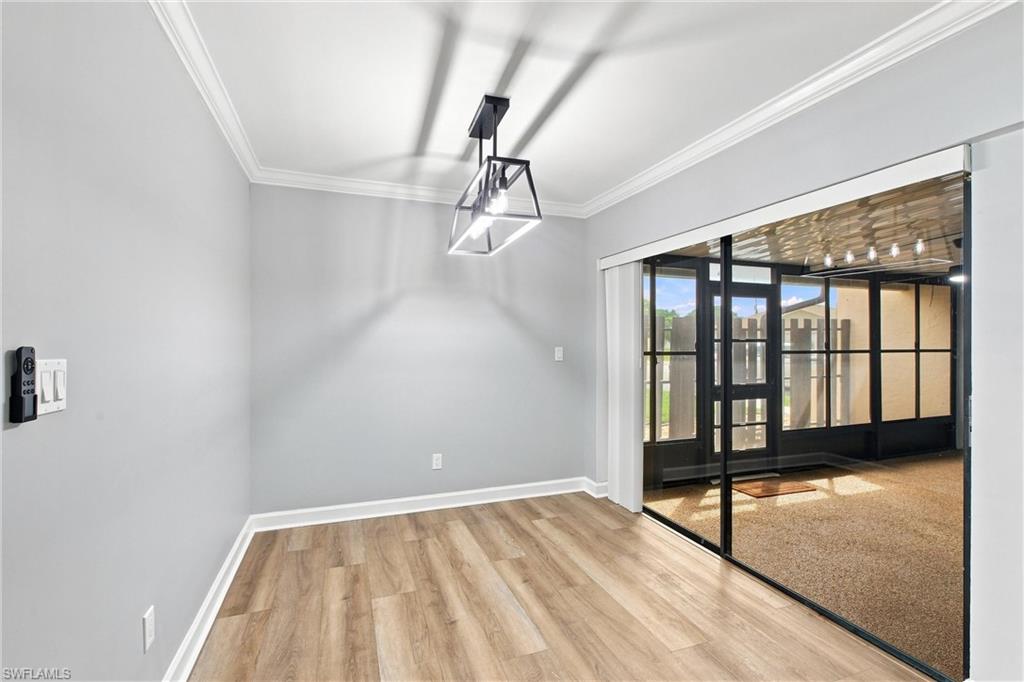 Dedicated dining space features a statement light fixture and seamless sliding glass door access to your private screened lanai.