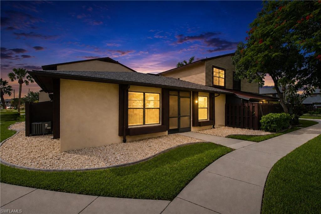 Experience beautiful evening ambiance with warm interior lighting and gorgeous sunset skies framing your next home.