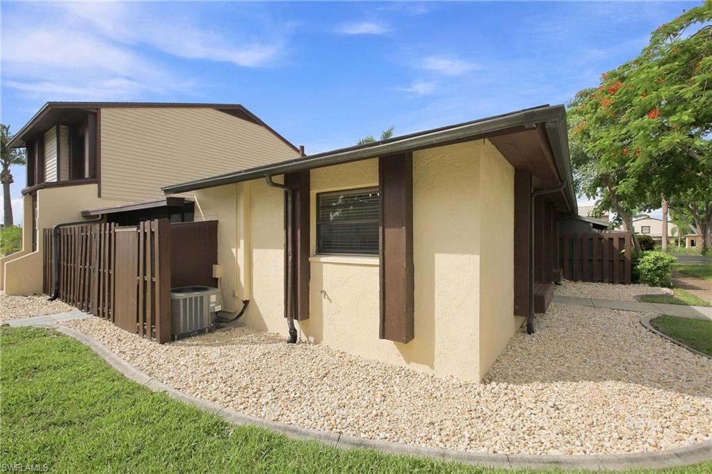 Pristine side exterior showcases low-maintenance decorative rock landscaping.