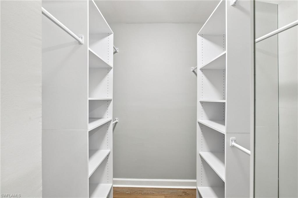 Primary Bedroom has an incredible walk-in closet comes fully equipped with custom built-in shelving, drawers, and ample hanging rods for maximum storage.