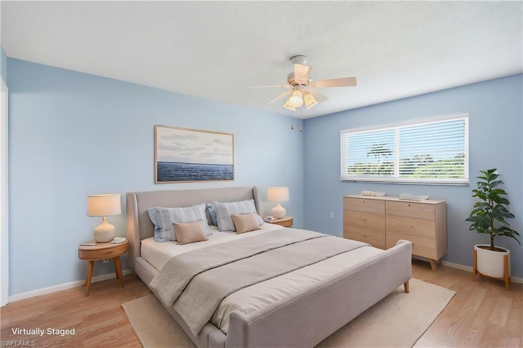 PRIMARY BEDROOM SUITE WITH UPDATED IMPACT WINDOW AND FLOORING...VIRTUALLY STAGED.