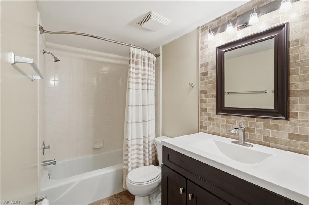 GUEST BATH WITH MODERN UPDATED VANITY, ACCENT WALL, AND CUSTOM LIGHTING..