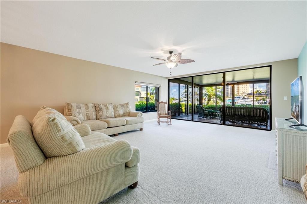 Expansive living area featuring light-colored carpeting and neutral wall tones