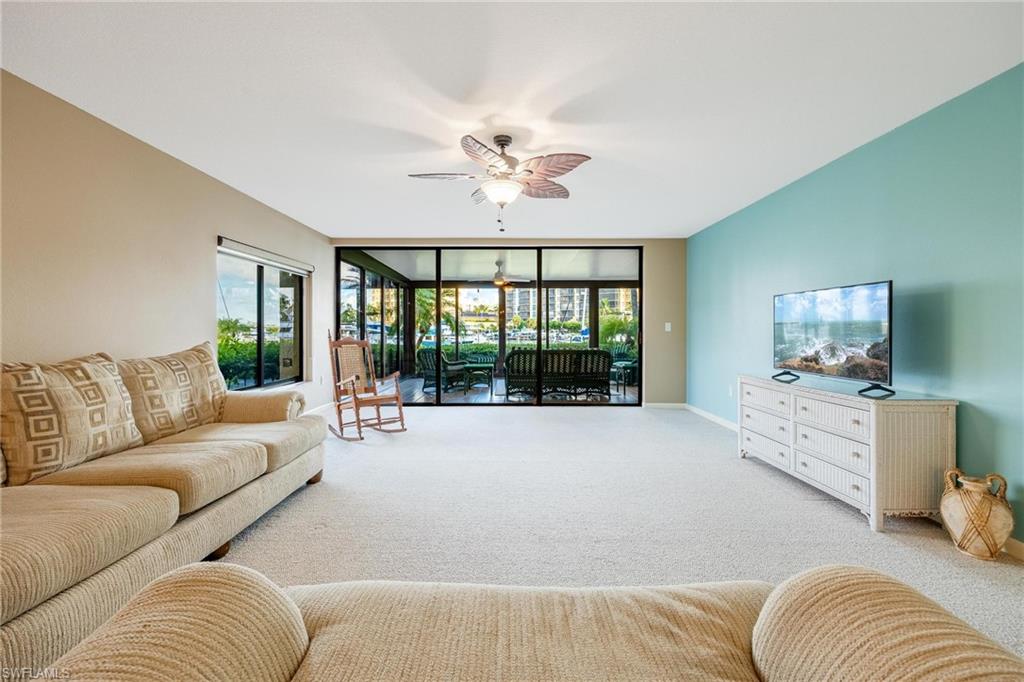 Expansive living area featuring light carpeting and neutral wall tones