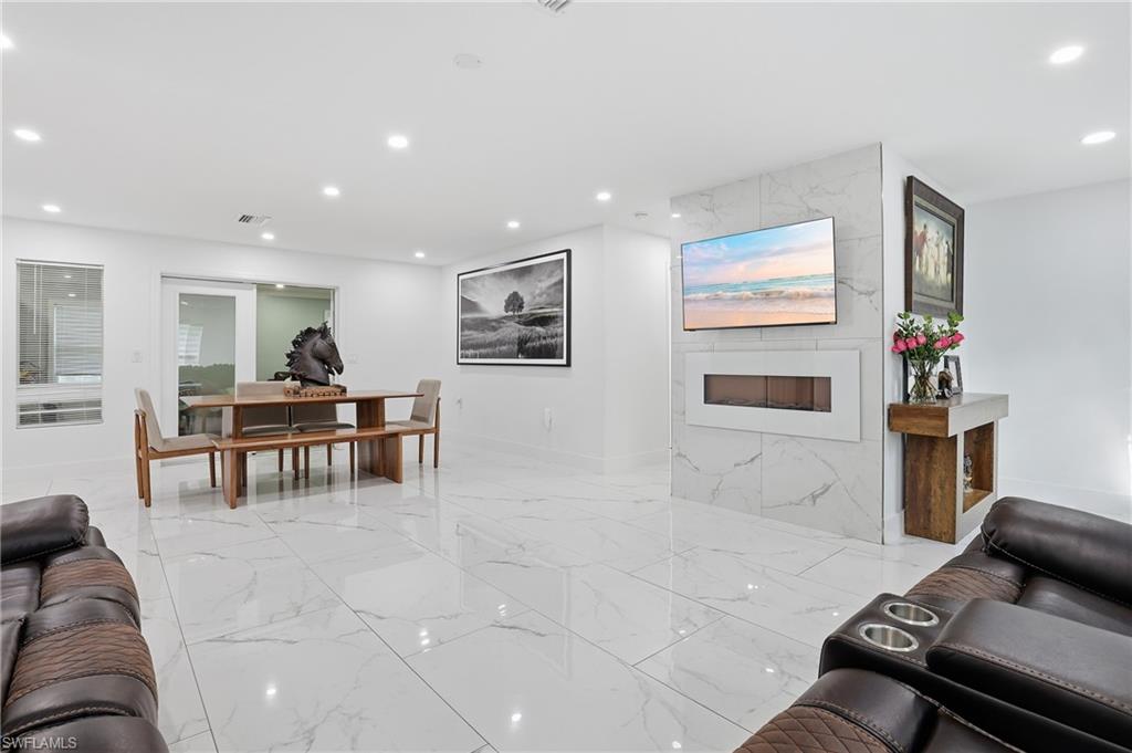 Recessed lighting illuminates polished tile flooring throughout