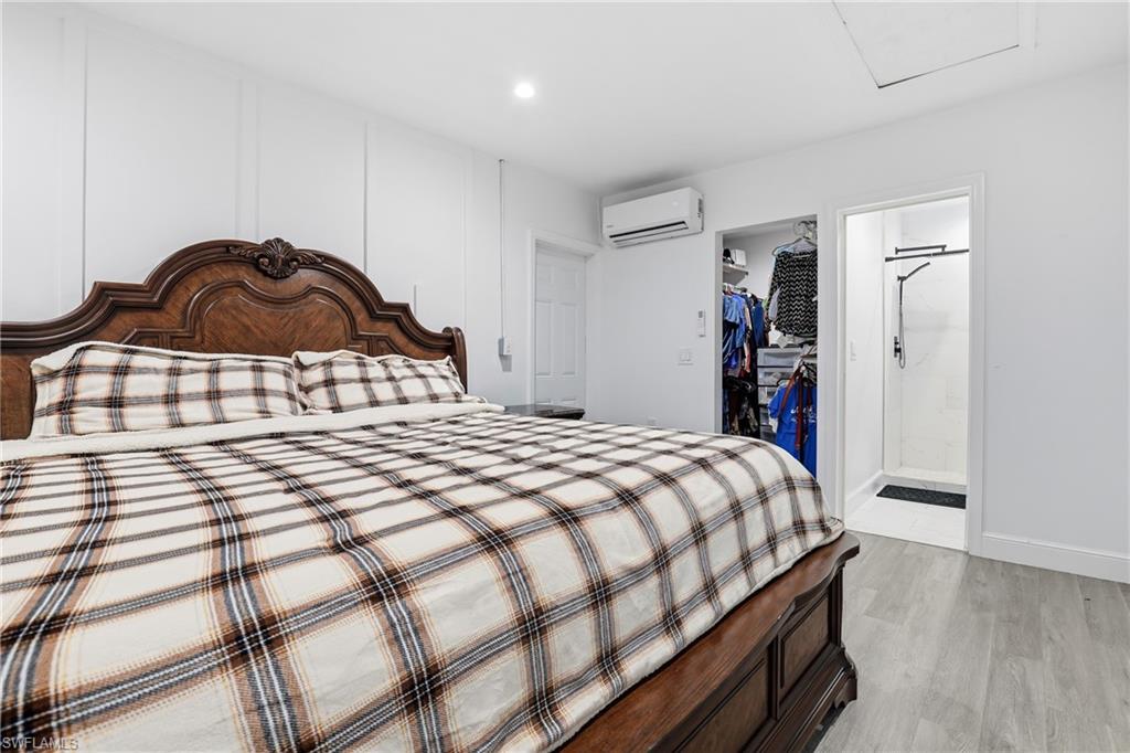 Recessed lighting, wood-finish flooring, built-in open closet, and attached shower