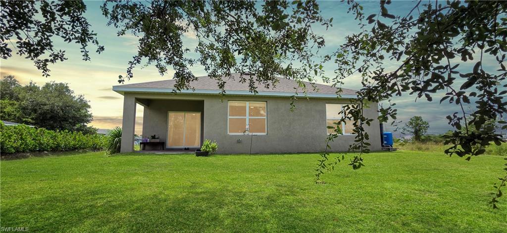 Expansive rear yard featuring a manicured lawn
