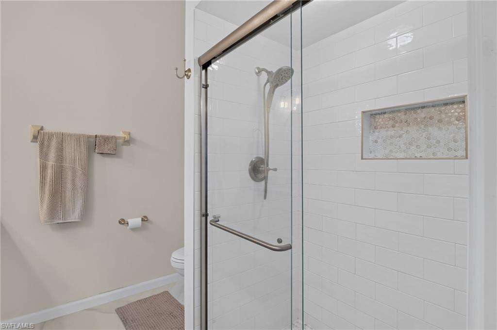 Shower enclosure featuring a glass sliding door and brushed nickel hardware