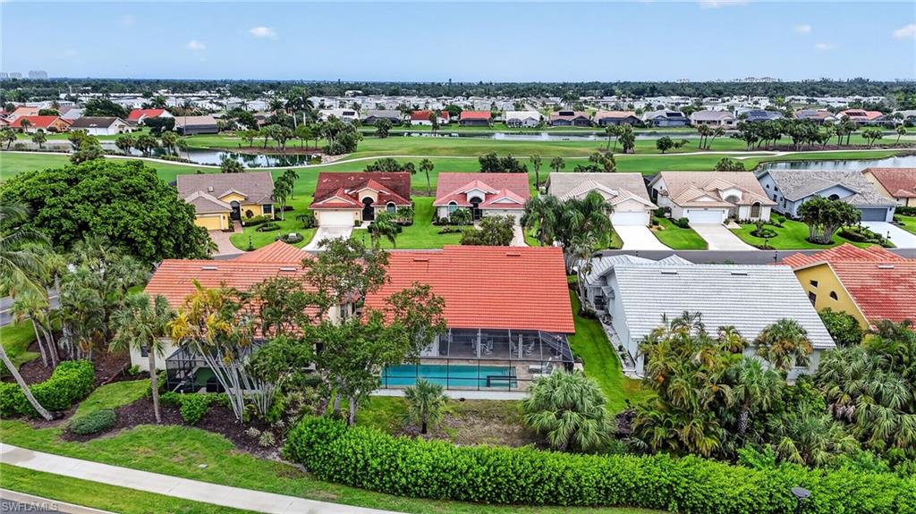 Aerial perspective of a residential community featuring diverse architectural styles and lush landscaping