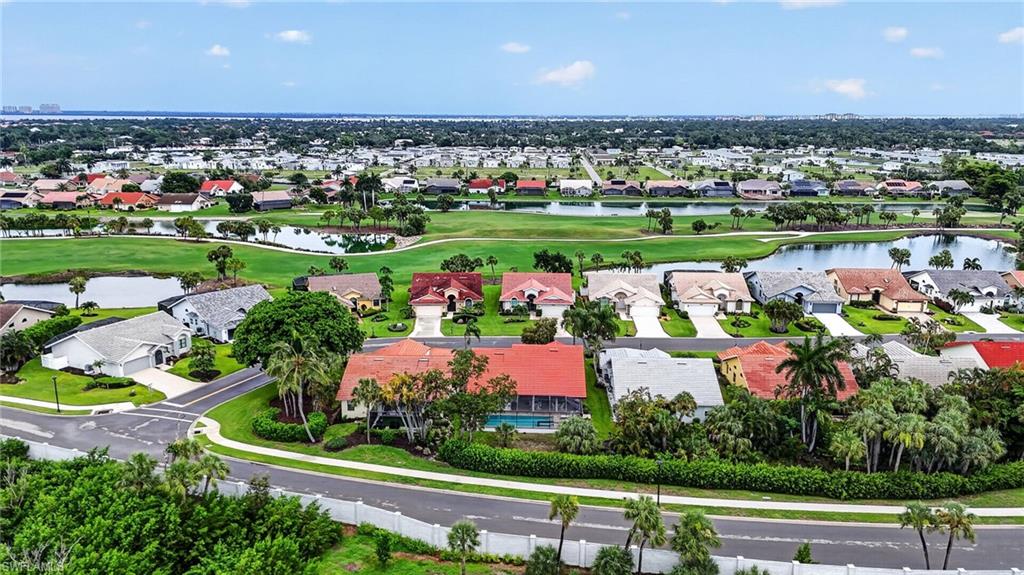 Aerial panorama showcasing a residential community with numerous properties featuring varied architectural styles and tiled roofs