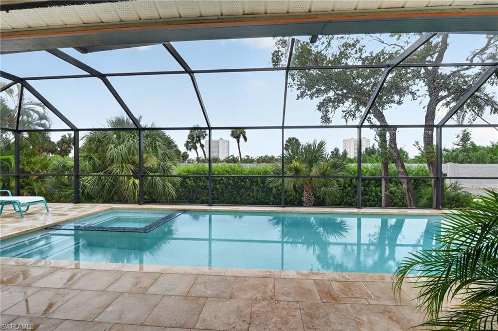 Screened lanai featuring a swimming pool and integrated spa