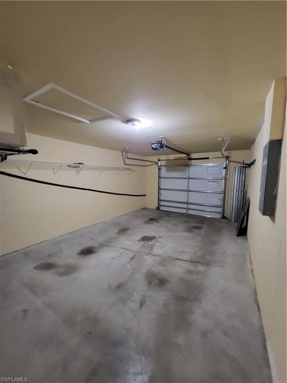 Garage featuring electric panel and a garage door opener
