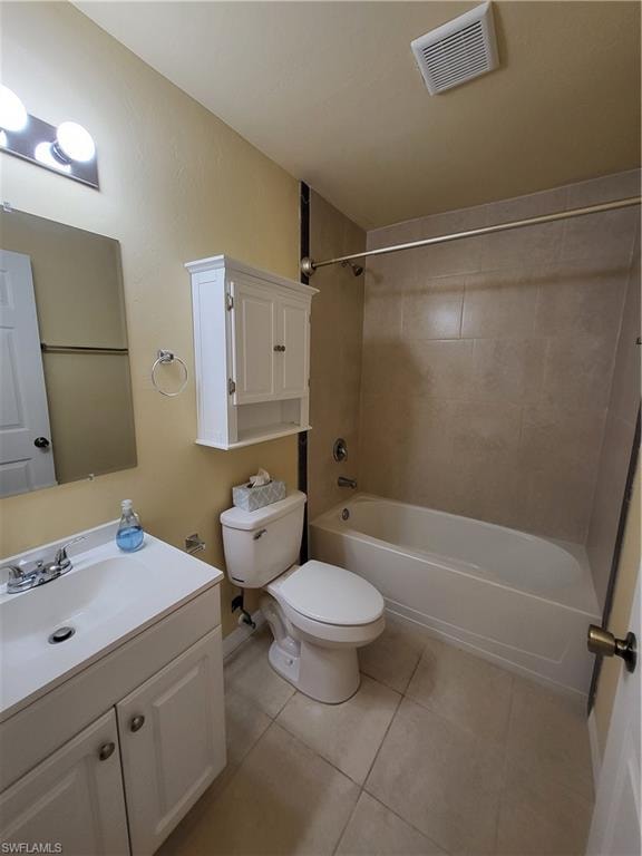 Bathroom with bathtub / shower combination, toilet, vanity, visible vents, and tile patterned floors