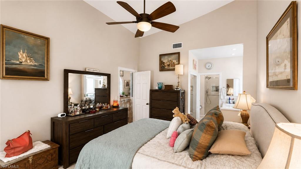 Vaulted ceiling with a ceiling fan, recessed doorway, and light-colored walls